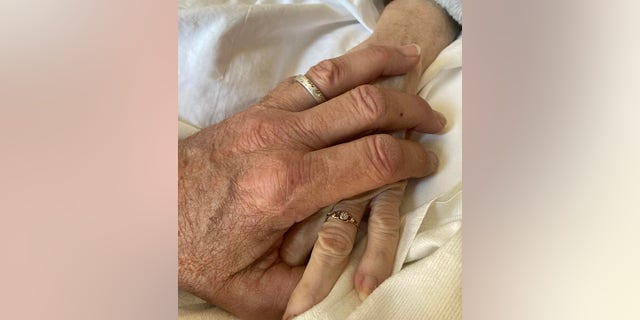 John Schneider posted a photo holding his wife's hand.