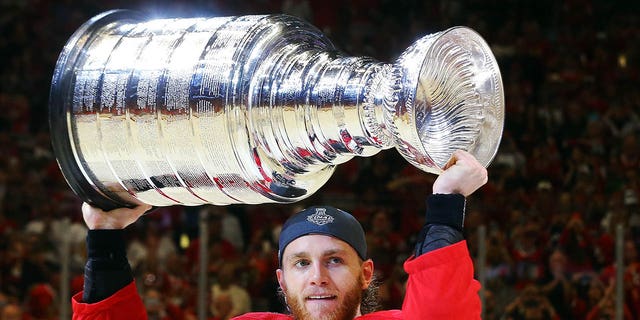 Patrick Kane of the Chicago Blackhawks celebrates by hoisting the Stanley Cup after defeating the Tampa Bay Lightning 2-0 in Game 6 to win the 2015 NHL Stanley Cup Final at the United Center June 15, 2015, in Chicago.  