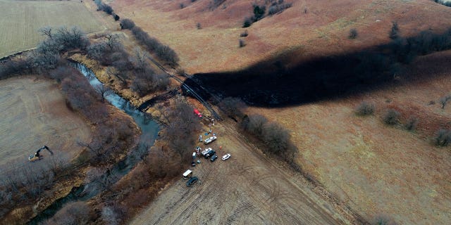 The company behind a large December oil spill in rural Kansas blames pressure and a poorly-welded pipe bend for the incident.