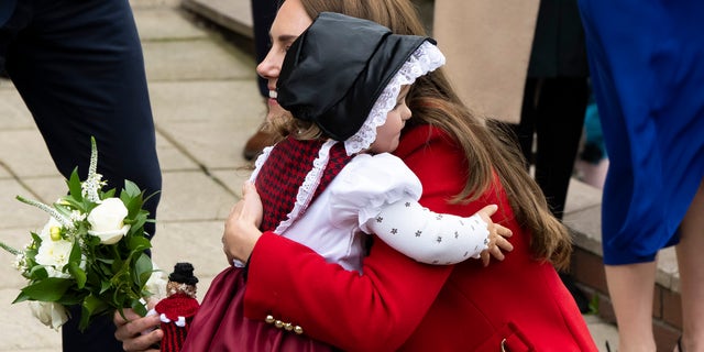 Catherine, Princess of Wales, hugs Charlotte Bunton after receiving flowers at St. Thomas Church Sept. 27, 2022, in Swansea, Wales. 