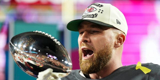 Travis Kelce #87 of the Kansas City Chiefs kisses the Lombardi Trophy after Super Bowl LVII against the Philadelphia Eagles at State Farm Stadium on February 12, 2023, in Glendale, Arizona. The Chiefs defeated the Eagles 38-35. 