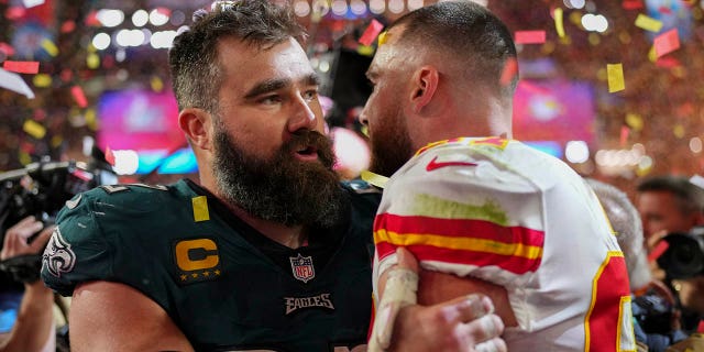 Jason Kelce #62 of the Philadelphia Eagles speaks with Travis Kelce #87 of the Kansas City Chiefs after Super Bowl LVII at State Farm Stadium on February 12, 2023, in Glendale, Arizona. The Chiefs defeated the Eagles 38-35. 