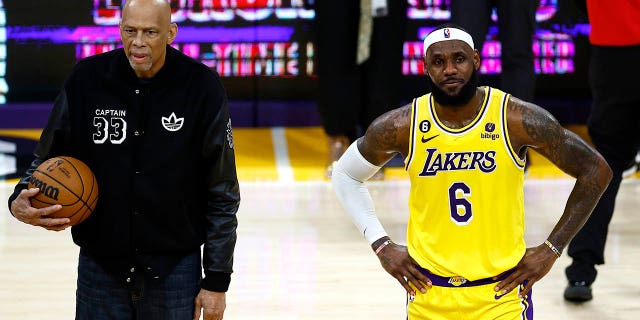 Kareem Abdul-Jabbar stands on court with LeBron James (6) of the Los Angeles Lakers after James passed Abdul-Jabbar to become the NBA's all-time leading scorer with 38,388 points against the Oklahoma City Thunder at Crypto.com Arena Feb. 7, 2023, in Los Angeles.