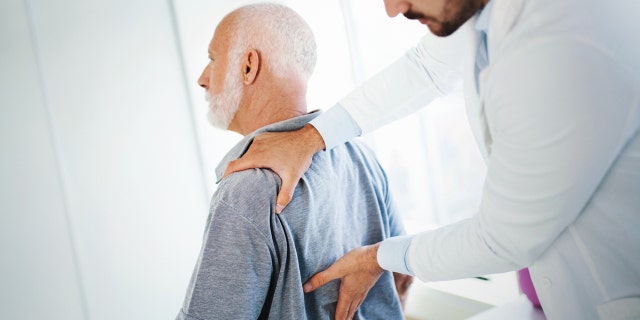 older man with back pain