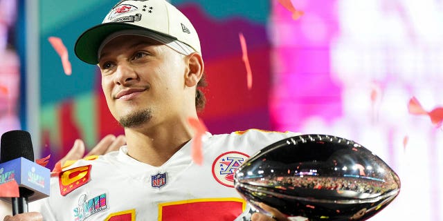 Patrick Mahomes #15 of the Kansas City Chiefs hoists the Lombardi Trophy after Super Bowl LVII against the Philadelphia Eagles at State Farm Stadium on February 12, 2023 in Glendale, Arizona. The Chiefs defeated the Eagles 38-35.