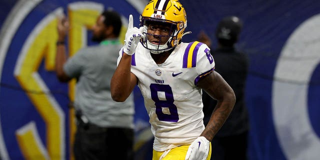 Malik Nabers of the LSU Tigers celebrates after scoring a 34-yard touchdown run against the Georgia Bulldogs during the third quarter in the SEC Championship game at Mercedes-Benz Stadium on December 3, 2022 in Atlanta.