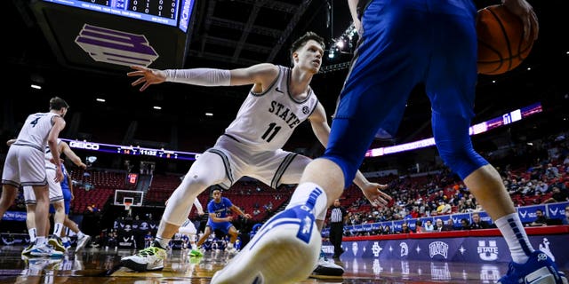 Max Shulga of the Utah State Aggies defends against Jake Heidbreder of the Air Force Falcons during their Mountain West Championship matchup at the Thomas and Mack Center in Las Vegas on March 9, 2022.