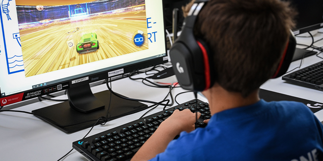 A boy plays video games during a free summer course for youth in Boulogne-Billancourt July 22, 2020.