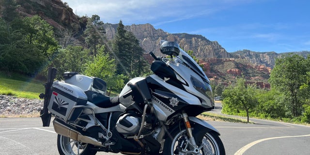An Arizona Department of Public Safety motorcycle sits on a roadway.
