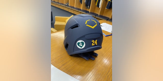 A Michigan State Spartans decal is seen placed on a University of Michigan baseball helmet following a deadly shooting on the East Lansing campus on Monday, Feb. 13, 2022.