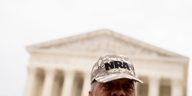 A person wears an NRA hat in front of the Supreme Court in Washington, D.C., on June 21, 2022.