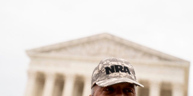 A person wears an NRA hat in front of the Supreme Court in Washington, D.C., on June 21, 2022.