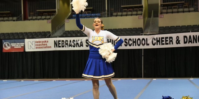 Katrina Kohel uses white cheerleading poms during her solo routine.