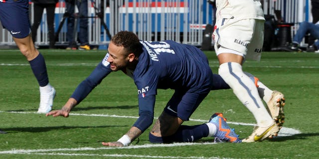 Neymar of PSG is injured after being tackled by Benjamin Andre of Lille during the Ligue 1 match between Paris Saint-Germain (PSG) and Lille OSC (LOSC) at Parc des Princes stadium on February 19, 2023, in Paris.