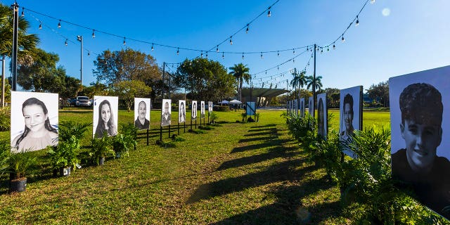 Photos of the 17 people killed during the Marjory Stoneman Douglas High School mass shooting are displayed on the fifth anniversary of the shooting on February 14, 2023, in Pine Trails Park in Parkland, Florida. On February 14, 2018, fourteen students and three staff members were killed during the shooting at the school. 