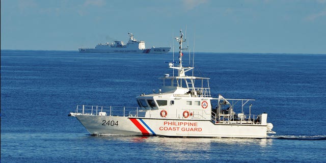 A Philippine coast guard ship sails in the South China Sea on May 14, 2019. The Filipino coast guard joined the U.S. Monday in search for a missing Taiwanese fishing vessel that was carrying six people.