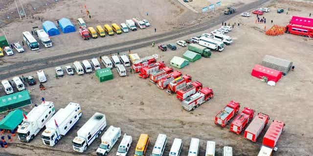 Rescue vehicles are parked near the site of a collapsed open pit coal mine in the Inner Mongolia Autonomous Region on Feb. 23, 2023. Five people were confirmed dead from the collapse.