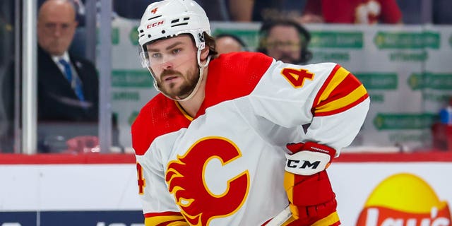 Rasmus Andersson of the Calgary Flames plays the puck against the Winnipeg Jets at Canada Life Centre on Jan. 3, 2023, in Winnipeg, Manitoba, Canada.