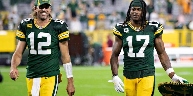 Aaron Rodgers (12) and Davante Adams (17) of the Green Bay Packers walk off the field after a game against the Detroit Lions at Lambeau Field Sept. 20, 2021, in Green Bay, Wisc. 