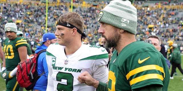 Zach Wilson of the New York Jets talks with Aaron Rodgers after beating the Packers, 27-10, at Lambeau Field on October 16, 2022 in Green Bay, Wisconsin.