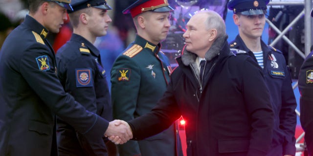 President Vladimir Putin greets members of the military during a concert in Luzhniki Stadium on Feb. 22, 2023, in Moscow, the same day he announced he was suspending Russian involvement in the New START treaty.