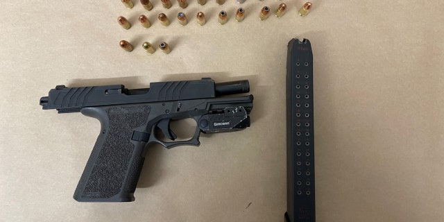 The gun seized from the suspects' car had an extended magazine and appeared to have been modified to make it fully automatic, police said.