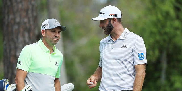 Dustin Johnson, right, and Sergio Garcia talk during the Players Championship on The Stadium Course at TPC Sawgrass on March 15, 2019, in Ponte Vedra Beach, Florida.