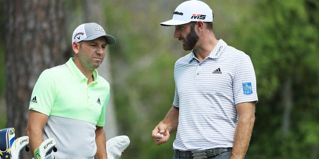 Dustin Johnson, right, and Sergio Garcia talk during the Players Championship on The Stadium Course at TPC Sawgrass on March 15, 2019, in Ponte Vedra Beach, Florida.