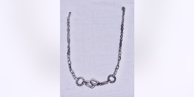 A silver necklace was found on the unidentified body. 