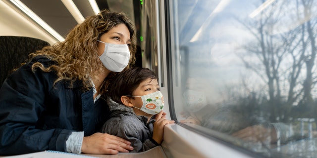 mother and son wearing masks