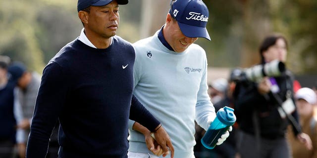 Tiger Woods of the United States (L) and Justin Thomas of the United States tee off the 9th tee during the first round of the Genesis Invitational at the Riviera Country Club on February 16, 2023 in Pacific Palisades, California. 