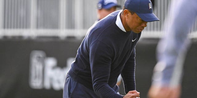 Tiger Woods celebrates with a raised fist after making a birdie putt on the 17th green during the first round of the Genesis Invitational at the Riviera Country Club on February 16, 2023, in Pacific Palisades, California.