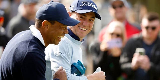 Tiger Woods of the United States and Justin Thomas of the United States cross the ninth hole during the first round of the Genesis Invitational at the Riviera Country Club on February 16, 2023 in Pacific Palisades, California. 