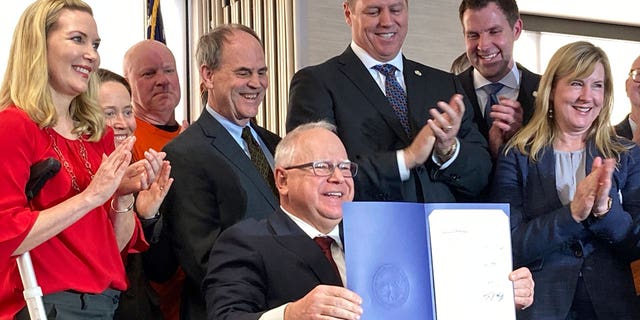 Democratic Minnesota Gov. Tim Walz on Tuesday signed a bill (not pictured) allowing more than 80,000 non-U.S. citizens to receive driver's licenses.