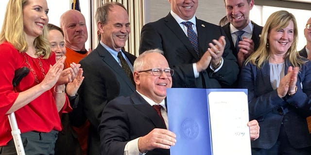 Democratic Minnesota Gov. Tim Walz on Tuesday signed a bill (not pictured) allowing more than 80,000 non-U.S. citizens to receive driver's licenses.