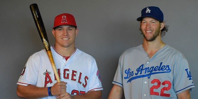 A behind-the-scenes photograph of Mike Trout of the Los Angeles Angels of Anaheim (left) and Clayton Kershaw of the Los Angeles Dodgers during a photo shoot before a game Aug. 7, 2014, at Angel Stadium of Anaheim in Anaheim, Calif. 