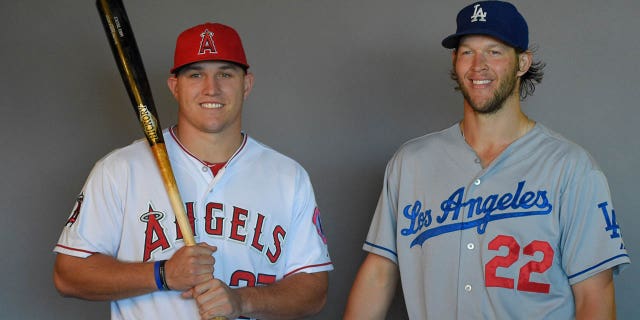 A behind-the-scenes photograph of Mike Trout of the Los Angeles Angels of Anaheim (left) and Clayton Kershaw of the Los Angeles Dodgers during a photo shoot before a game Aug. 7, 2014, at Angel Stadium of Anaheim in Anaheim, Calif.