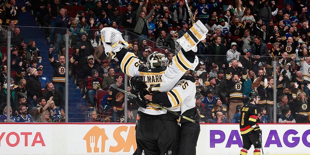 Linus Ullmark #35 of the Boston Bruins scores a goalie goal off a dropped net during the final seconds of their NHL game against the Vancouver Canucks at Rogers Arena on February 25, 2023 in Vancouver, British Columbia, Canada.  The Boston Bruins win 3-1.   