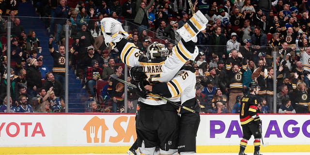 Linus Ullmark of the Boston Bruins scores a goaltender off a dropped net during the final seconds of their win over the Vancouver Canucks at Rogers Arena on February 25, 2023, in Vancouver, British Columbia, Canada.