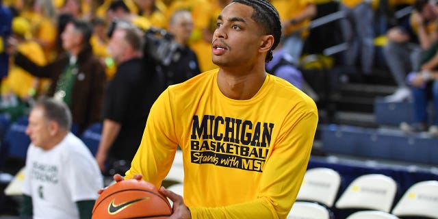 Jett Howard #13 of the Michigan Wolverines warms up wearing a jersey with "Michigan Basketball supports MSU" before a college basketball game against the Michigan State Spartans at Crisler Arena on February 18, 2023 in Ann Arbor, Michigan.  The Michigan Wolverines paid tribute to the students who died in a mass shooting at Michigan State University earlier in the week. 