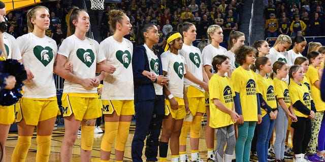 Michigan Wolverines women's basketball players are seen wearing special jerseys in support of Michigan State University before a college basketball game against the Ohio State Buckeyes at Crisler Arena on February 20, 2023 in Ann Arbor, Michigan.  The Michigan Wolverines paid tribute to the students who were killed or affected by a mass shooting at Michigan State University the previous week.