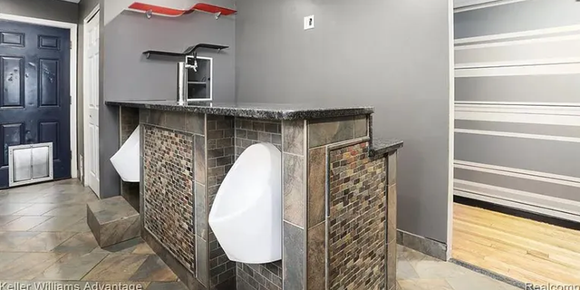 The three-bedroom, one-bathroom house at 3050 Burdette Street in Ferndale, Michigan, has two urinals built into its kitchen bar.