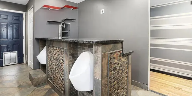 The three-bedroom, one-bathroom house at 3050 Burdette Street in Ferndale, Michigan, has two urinals built into its kitchen bar.