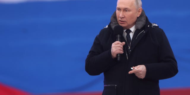 Russian President Vladimir Putin speaks during a concert in Luzhniki Stadium in Moscow.