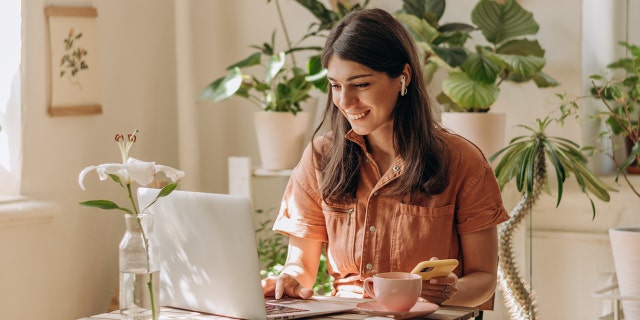 A woman working form home with a laptop.