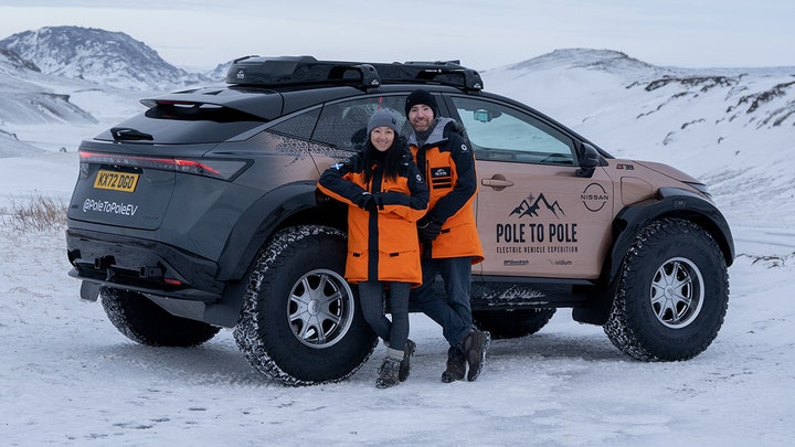 Married couple driving from North Pole to South Pole