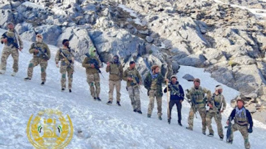 NRF fighters stand on the snowy mountains of Afghanistan
