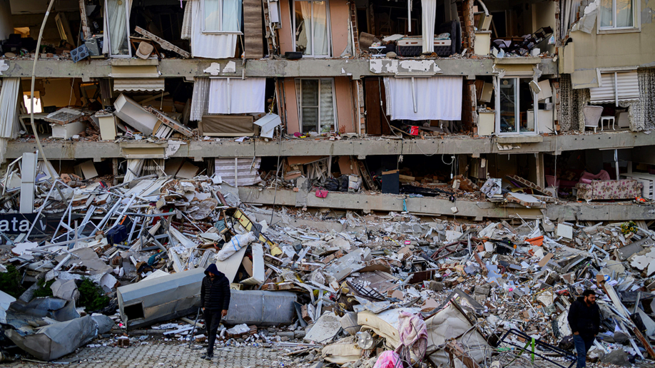 Turkish man walks among earthquake rubble