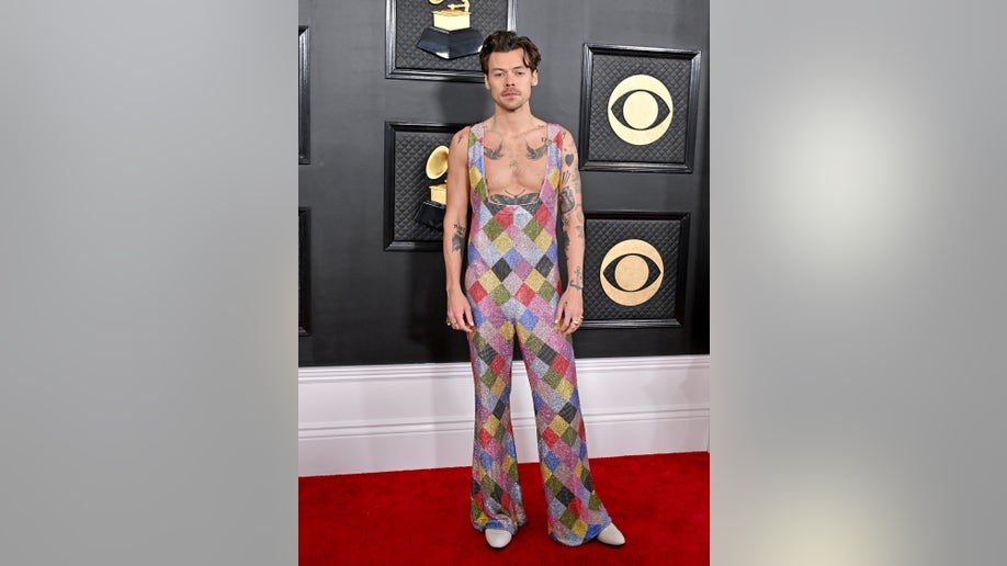 Harry Styles wears a colorful jumpsuit on the red carpet for the 2023 Grammy Awards.