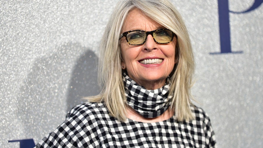 Diane Keaton smiling in black and white outfit